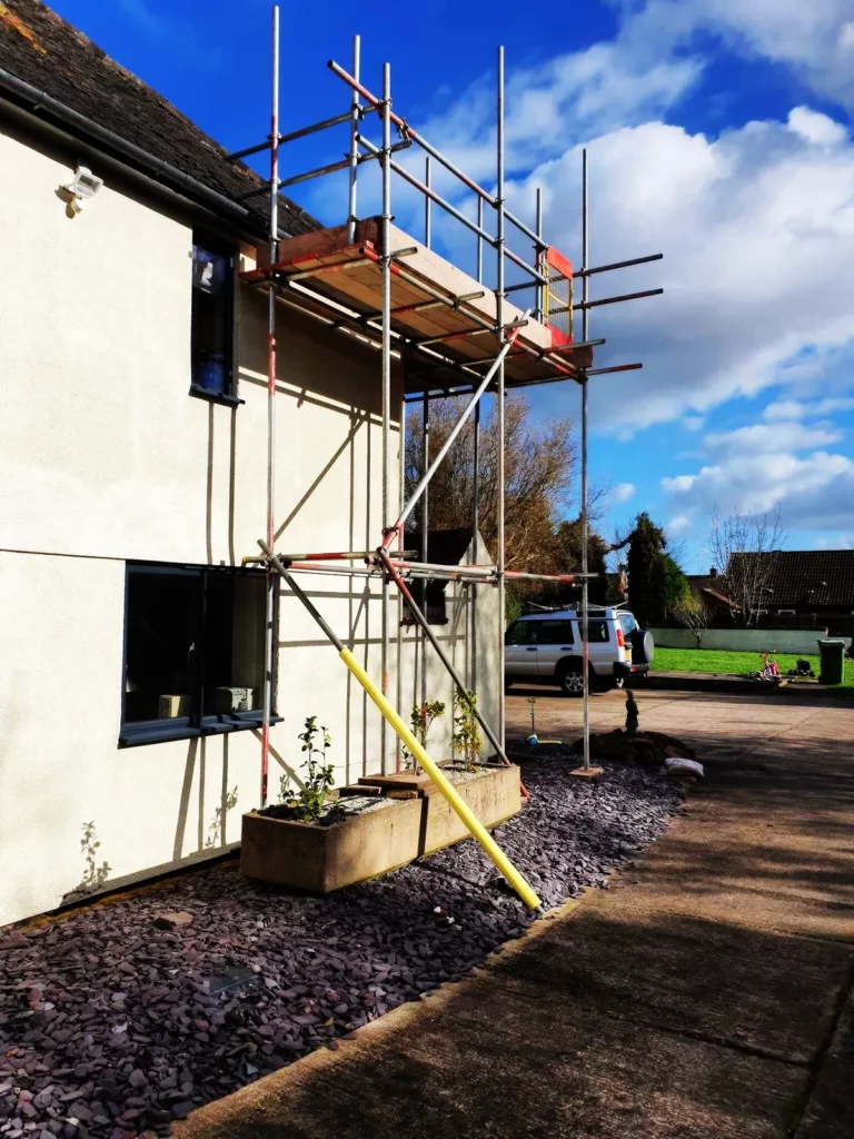 Scaffolding up the side of a white rendered house