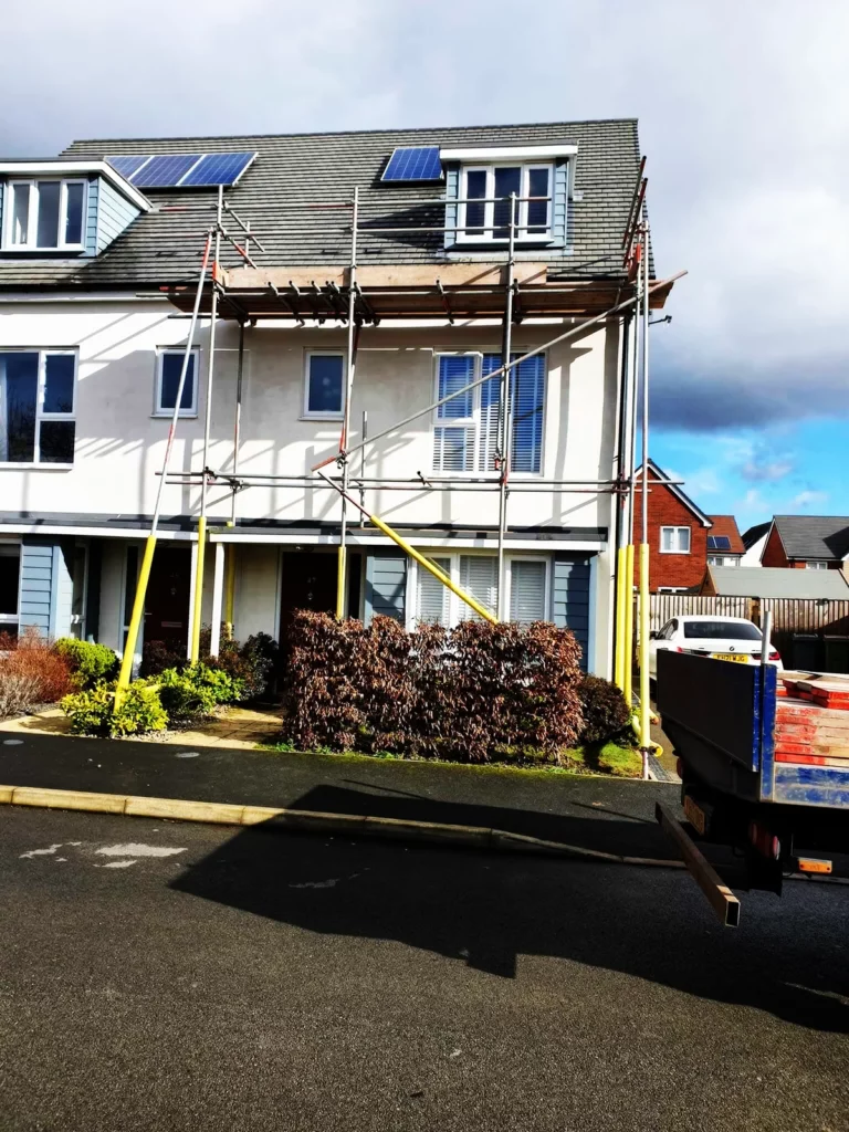 Scaffolding on a three-storey new-build house with solar panels