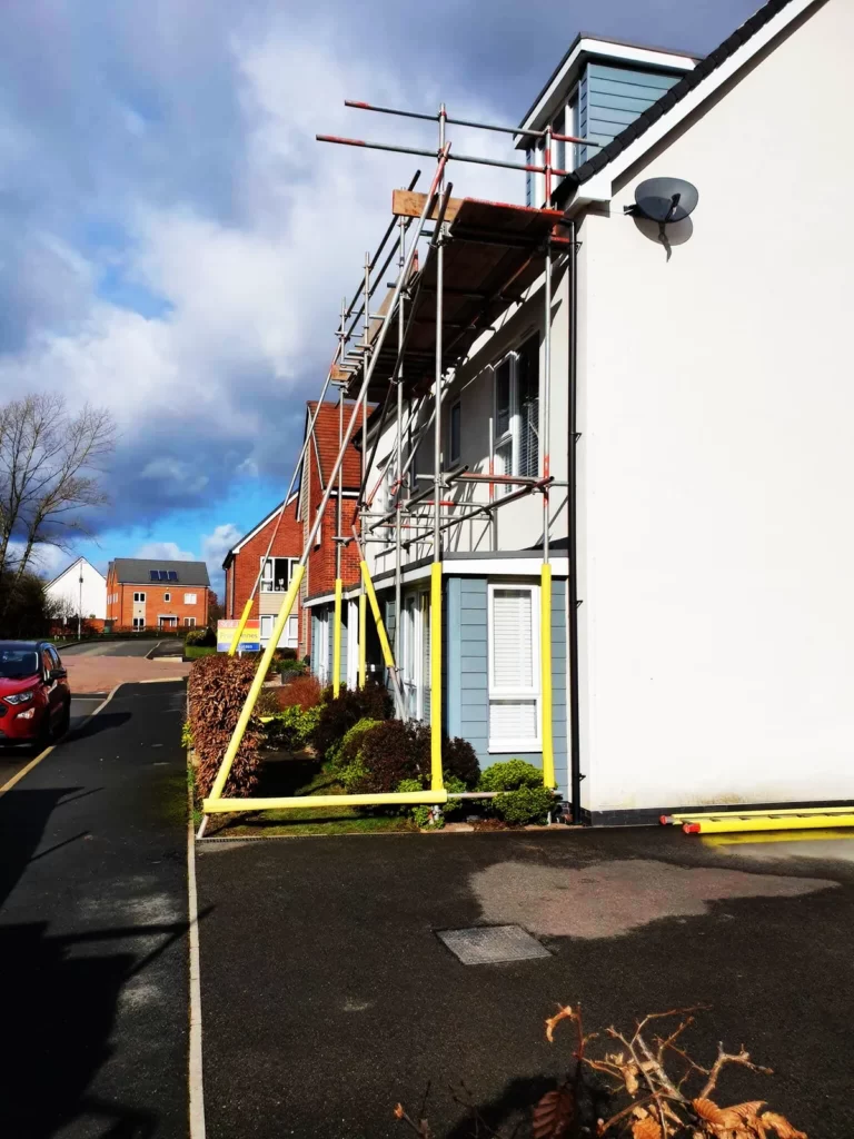 Scaffolding along the side of a modern townhouse
