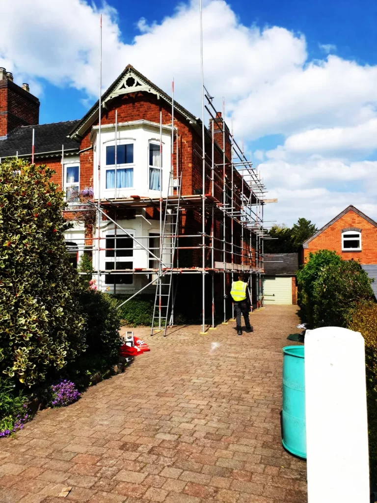Scaffolding up the front of a Victorian house with a bay window